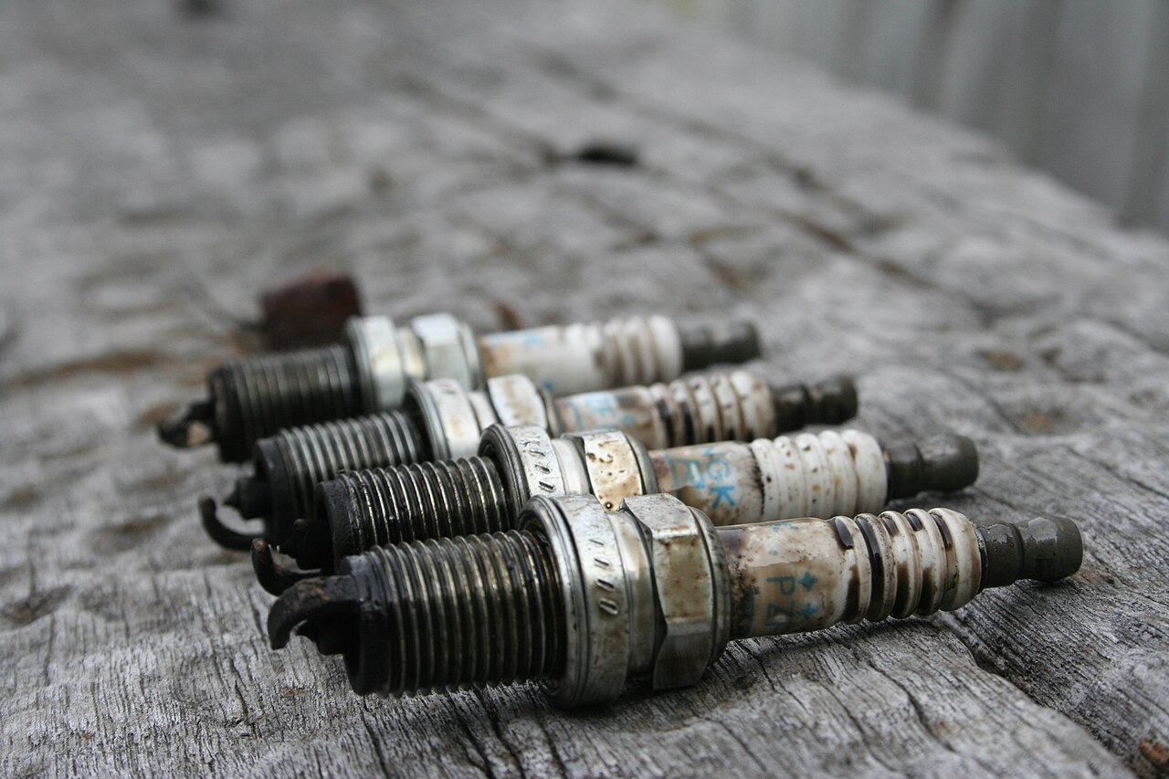 Used automotive spark plugs on a workbench